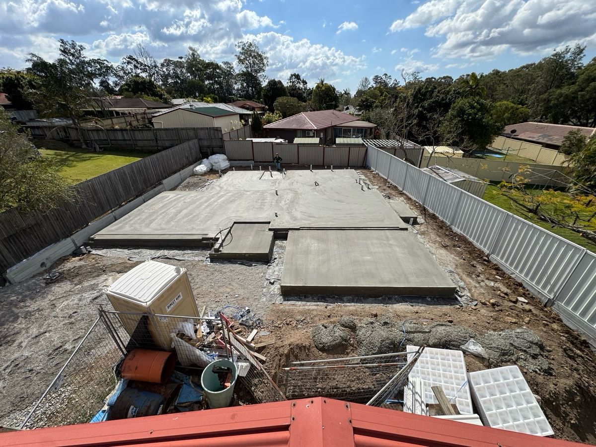 9 Sep 2026 from the same roof: a poured concrete slab, a portable toilet and site fencing, with the same back fence and houses behind.